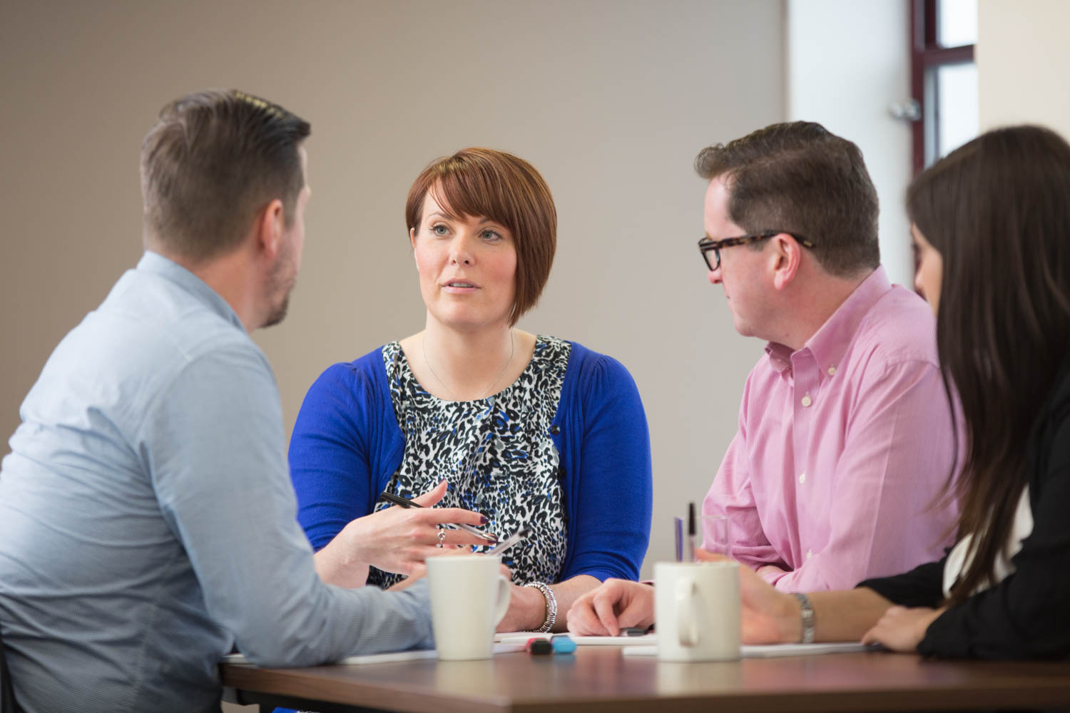 group of people talking around a table