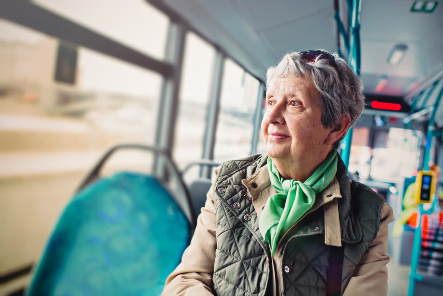 A woman looking out of the window of a bus