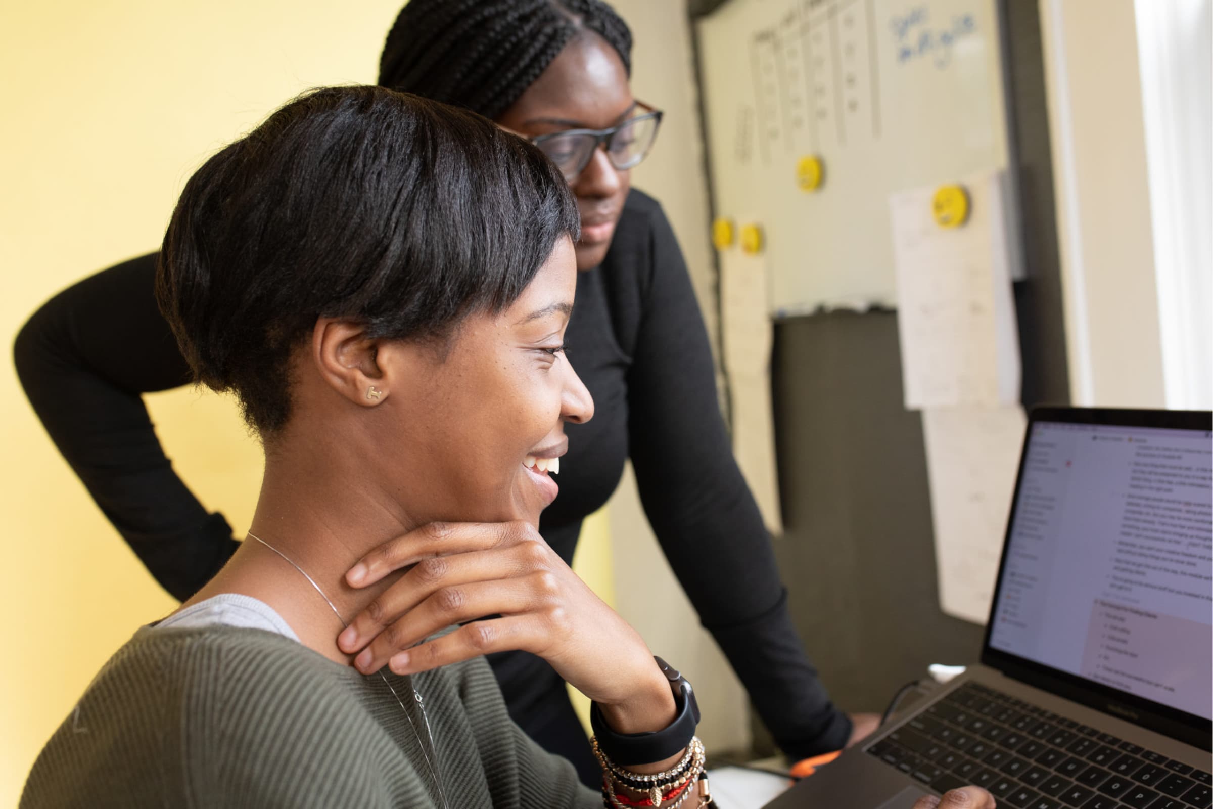 banner of two women using a computer