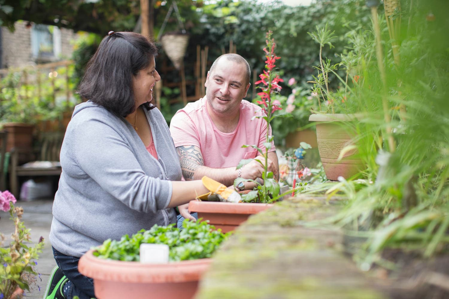 A man and woman talking in a garden